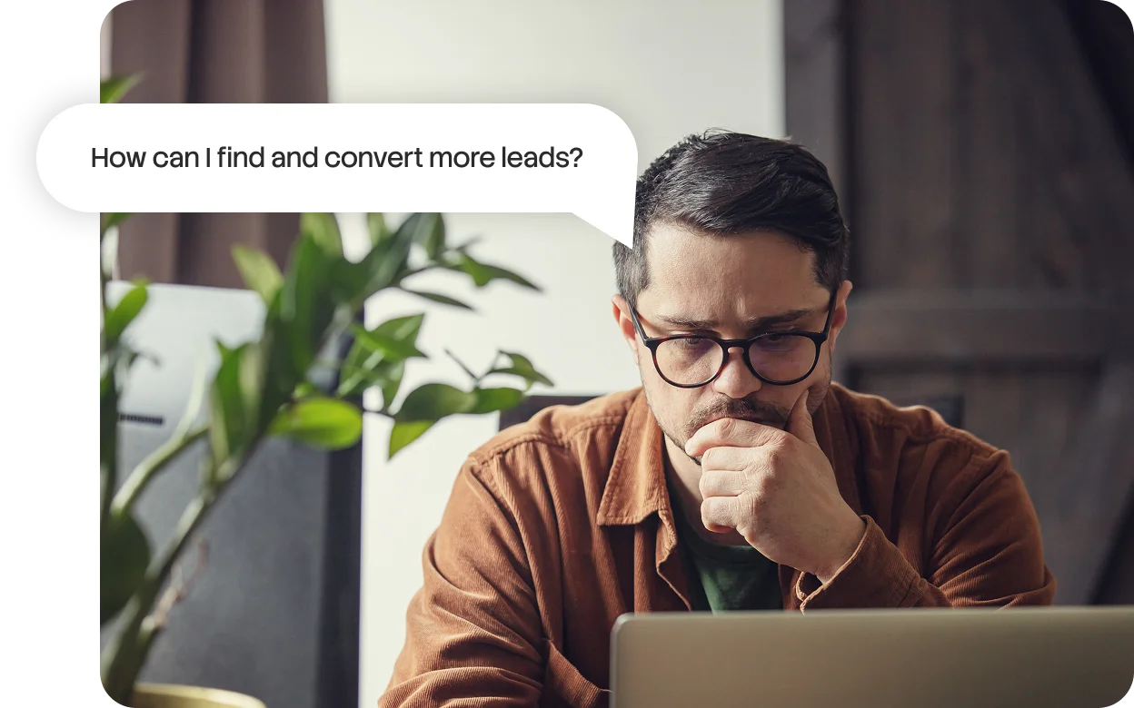 usiness owner thinking at his laptop, wondering how to find and convert more lead