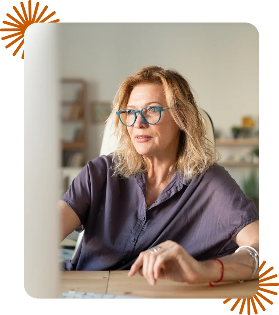 Therapist working at her desktop computer, representing HIPAA-aware website design for private practices