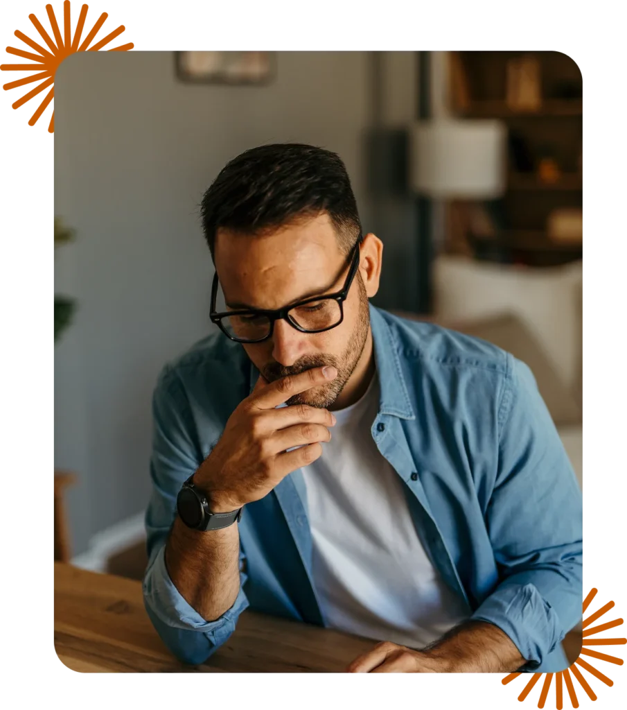 Small business owner thinking through his website and marketing strategy at his desk